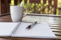 Selective focus of Pen, notebook , coffee cup on the wooden table and copy space Royalty Free Stock Photo