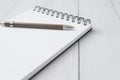 Selective focus of Pen and notebook  on white wooden table and copy space Royalty Free Stock Photo