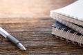 Selective focus of Pen, notebook on the wooden table and copy space  with sunlight Royalty Free Stock Photo