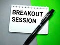 Selective focus.Pen and word BREAKOUT SESSION on notebook with green and gray background. Royalty Free Stock Photo