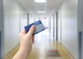 Selective focus on person hand holding blank European Health Insurance Card inside medical hospital. Royalty Free Stock Photo