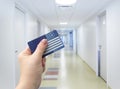 Selective focus on person hand holding blank European Health Insurance Card inside medical hospital. Royalty Free Stock Photo