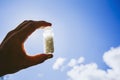 Selective focus on person hand holding glass jar full of small white round homeopathy pills. Royalty Free Stock Photo