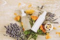 Selective focus on person hand holding glass jar full of small white round homeopathy pills against bokeh forest nature background Royalty Free Stock Photo