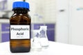 Selective focus of Phosphoric acid solution in brown amber bottle. Blur white laboratory backdrop with copy space.