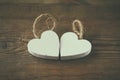 Selective focus photo of couple of wooden hearts on rustic table. valentine's day celebration concept.