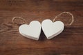 Selective focus photo of couple of wooden hearts on rustic table. valentine's day celebration concept.