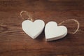 Selective focus photo of couple of wooden hearts on rustic table. valentine's day celebration concept.