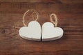 Selective focus photo of couple of wooden hearts on rustic table. valentine's day celebration concept.