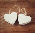 Selective focus photo of couple of wooden hearts on rustic table. valentine's day celebration concept.