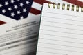 selective focus photo of open notepad with blank space, on a background of paycheck protection program borrower application form Royalty Free Stock Photo