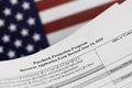 selective focus photo of paycheck protection program borrower application form revised on a background of United States flag.