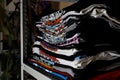 Selective focus photo of t-shirts with bright prints, printed by silkscreen. serigraphy production. printing images on t-shirts in
