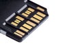 Selective focus photo of two rows of golden contacts on back of UHS-II high speed memory card isolated on white background close