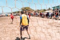 Selective focus photo of an unrecognizable goalkeeper protecting the goal during a soccer game on a beach in Masachapa