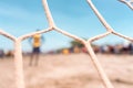 Selective focus photo of an unrecognizable goalkeeper watching the action of a soccer game on a beach in Masachapa