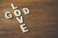 Selective focus photo of The words love is god made with block wooden letters on wooden background. religion concept Royalty Free Stock Photo