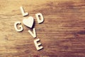 Selective focus photo of The words love is god made with block wooden letters on wooden background. religion concept Royalty Free Stock Photo