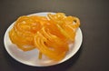Selective focus picture of Indian Traditional Sweet called Jelebi kept in white plate