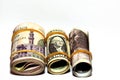 Pile of American dollars rolls with rolled up Egyptian money banknote bills of 100 LE, 200 LE