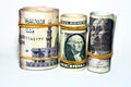 Pile of American dollars rolls with rolled up Egyptian money banknote bills of 100 LE, 200 LE