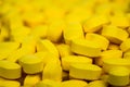 Selective focus on pile of yellow tablets pills . Ibuprofen tablets pills. Painkiller medicine for headache, high fever