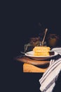 selective focus of plate with honeycombs and jars with honey on black