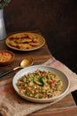 Selective focus of a plate of traditional cuisine called oblok-oblok on a wooden table