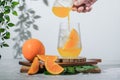 Selective focus, pouring orange soda into glass on white background. soft drink is fresh summer drink in the morning, iced orange Royalty Free Stock Photo