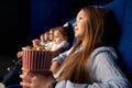 Little friends watching cartoon in cinema.