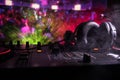 In selective focus of Pro dj controller.The DJ console deejay mixing desk at music party in nightclub with colored disco lights. Royalty Free Stock Photo