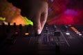 In selective focus of Pro dj controller.The DJ console deejay mixing desk at music party in nightclub with colored disco lights. Royalty Free Stock Photo