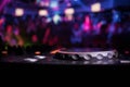 In selective focus of Pro dj controller.The DJ console deejay mixing desk at music party in nightclub with colored disco lights. Royalty Free Stock Photo