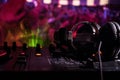 In selective focus of Pro dj controller.The DJ console deejay mixing desk at music party in nightclub with colored disco lights. Royalty Free Stock Photo