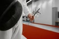 Selective focus on protective fencing mask in hand of young fencer