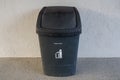 Selective focus public black plastic bin for garbage Royalty Free Stock Photo