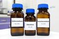 Selective focus of pure dichloromethane, chloroform and tetrachloromethane liquid chemical compound set in dark glass bottles. Royalty Free Stock Photo