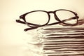 selective focus on reading eyeglasses with stacking of newspaper Royalty Free Stock Photo