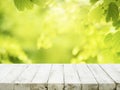 selective focus.real white wood table top texture on blur leaf tree garden background Royalty Free Stock Photo