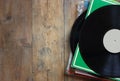 Selective focus of records stack with record on top over wooden table. vintage filtered Royalty Free Stock Photo