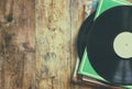 Selective focus of records stack with record on top over wooden table. vintage filtered Royalty Free Stock Photo