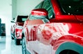 Selective focus red car parked in luxury showroom. Car dealership office. New car parked in modern showroom. Car for sale and rent Royalty Free Stock Photo