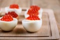 Selective focus. Red caviar on halves of hard-boiled chicken egg Royalty Free Stock Photo