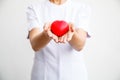 Selective focus of red heart held by female nurse`s both hand, representing giving all effort to deliver high quality service mind Royalty Free Stock Photo