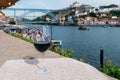 Red wine glass overlooking Cais da Ribeira on the River Douro in Porto, Portugal Royalty Free Stock Photo