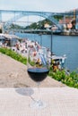 Red wine glass overlooking Cais da Ribeira on the River Douro in Porto, Portugal Royalty Free Stock Photo
