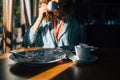 Selective focus remains of dessert on table and girl drinking coffee on background. Young woman indoors finished eating cake and