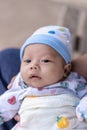 Selective focus on right eye of adorable newborn baby child boy resting in mother`s arms at home Royalty Free Stock Photo