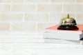 Selective focus of ring bell and stack of books isolated with copy space for text Royalty Free Stock Photo