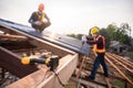 Selective focus Roofing tools, Roofer worker using a electric drill install on new roof metal sheet at construction site